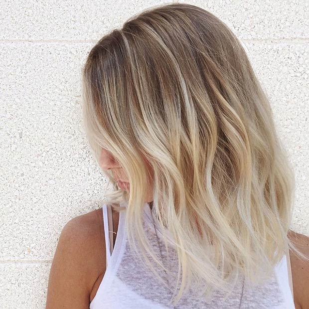 textured long bob hairstyle with blonde balayage